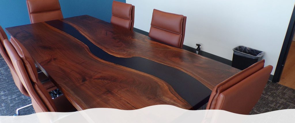 A live edge river table positioned in a conference room